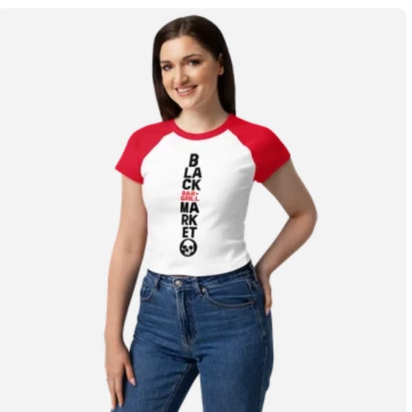 Woman wearing a white and red Black Market Bar & Grill t-shirt with a skull logo.