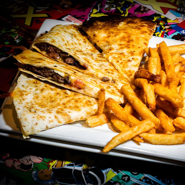 A plate of Black Market Bar and Grill's quesadillas with fries on a comic book background.