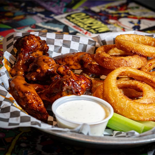 Black Market Bar and Grill's BBQ wings and onion rings with ranch and celery.