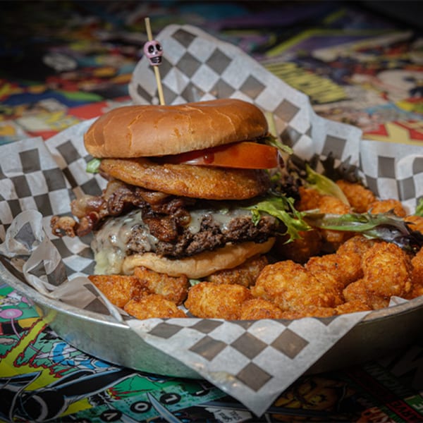 A Black Market Bar and Grill burger with bacon, cheese, lettuce, tomato, and tater tots.